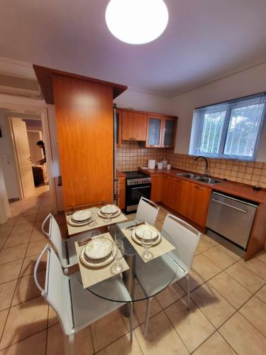 a kitchen with a table and chairs in a kitchen at Dilion Guest Apartment in Dhílesi