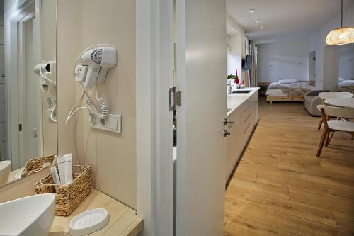 a bathroom with a hair dryer on the wall at Eva's Pavaroti in Tbilisi City