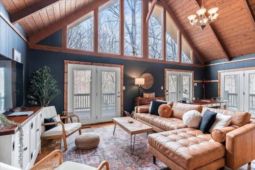 a living room with a couch and a table at Spacious Lakeview Mountain Cabin in Powderhorn Mountain