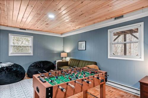 a living room with a foosball table at Spacious Lakeview Mountain Cabin in Powderhorn Mountain