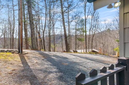 a house with a fence on the side of a road at Spacious Lakeview Mountain Cabin in Powderhorn Mountain