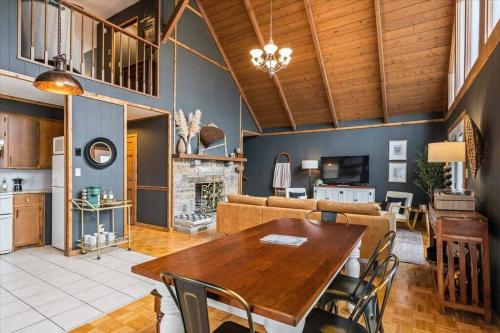 a living room with a wooden table and a couch at Spacious Lakeview Mountain Cabin in Powderhorn Mountain