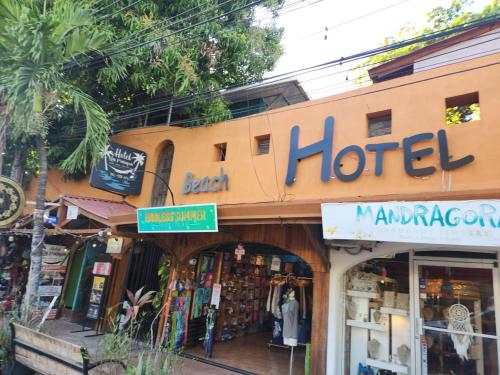 a hotel sign on the front of a store at Hotel La Palapa in Tamarindo