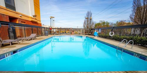 a large blue swimming pool in front of a building at Hyatt Place Atlanta Airport North in Atlanta