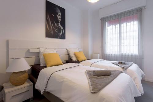 a bedroom with two beds and a window at Palais Armenonville Cannes avec Parking proche Carlton Croisette in Cannes