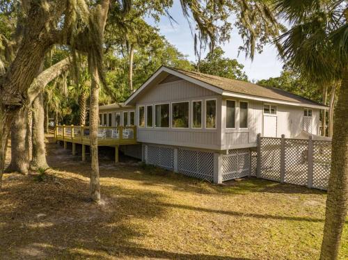 a large white house with trees in front of it at 4bd/3ba - Renovated Center Island Home & Garage Apt - Amenity Cards Avail - Pets ok in Fripp Island
