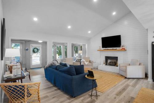 a living room with a blue couch and a fireplace at 4bd/3ba - Renovated Center Island Home & Garage Apt - Amenity Cards Avail - Pets ok in Fripp Island
