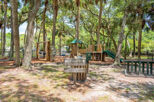 a park with a playground with a sign that says park open at 4bd/3ba - Renovated Center Island Home & Garage Apt - Amenity Cards Avail - Pets ok in Fripp Island