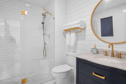 a bathroom with a toilet and a sink and a mirror at 4bd/3ba - Renovated Center Island Home & Garage Apt - Amenity Cards Avail - Pets ok in Fripp Island