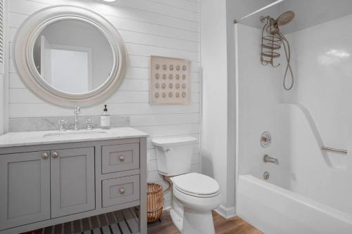 a bathroom with a sink and a toilet and a mirror at 4bd/3ba - Renovated Center Island Home & Garage Apt - Amenity Cards Avail - Pets ok in Fripp Island