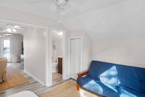 a living room with a blue couch in a room at 4bd/3ba - Renovated Center Island Home & Garage Apt - Amenity Cards Avail - Pets ok in Fripp Island