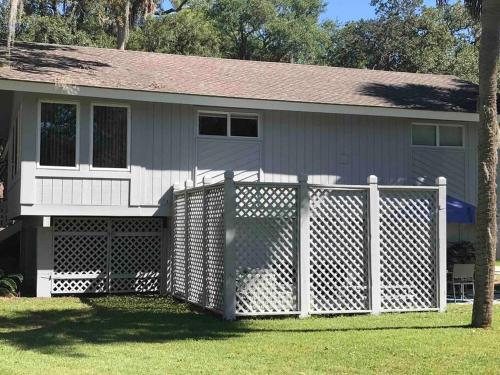 a white fence in front of a house at 4bd/3ba - Renovated Center Island Home & Garage Apt - Amenity Cards Avail - Pets ok in Fripp Island