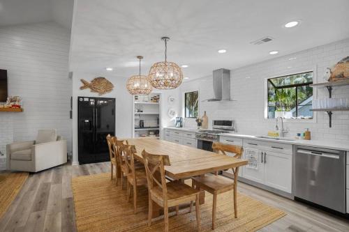 a large kitchen with a wooden table and chairs at 4bd/3ba - Renovated Center Island Home & Garage Apt - Amenity Cards Avail - Pets ok in Fripp Island