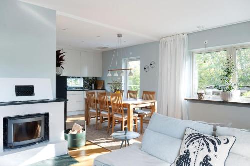 a kitchen and living room with a table and chairs at Stor villa nära till centrala Stockholm in Stockholm