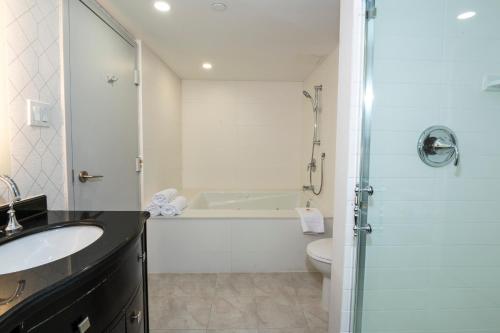 a bathroom with a tub and a sink and a toilet at Comfort Inn & Conference Centre Toronto Airport in Toronto