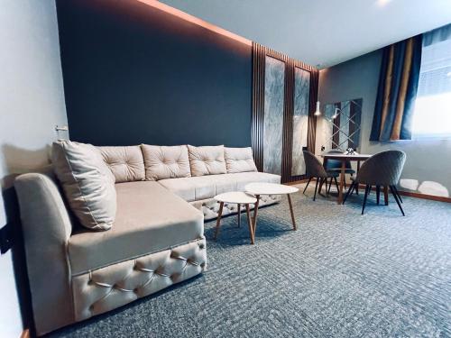 a living room with a couch and a table at MOZAIK APARTMENTS & SPA - Modern 4-Star Apartments with Exclusive Private SPA WELLNESS in the City Center - SAUNA, JACUZZI, TURKISH BATH - FREE PARKING, Wi-FI - Rooms & Apartments Cuprija in Ćuprija