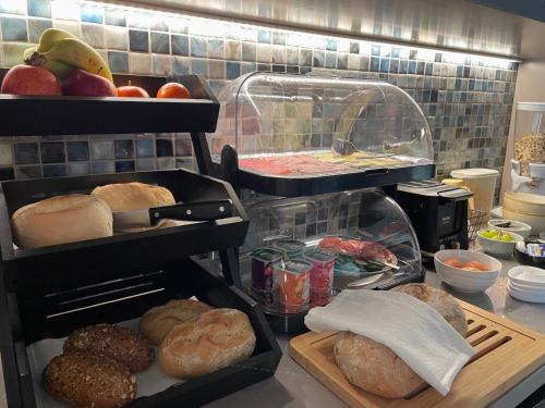 a kitchen with bread and pastries on a counter at Casa do Mundo Madeira in Gaula