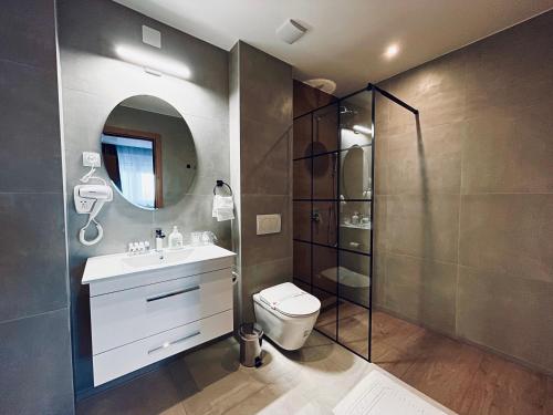 a bathroom with a toilet and a sink and a shower at MOZAIK APARTMENTS & SPA - Modern 4-Star Apartments with Exclusive Private SPA WELLNESS in the City Center - SAUNA, JACUZZI, TURKISH BATH - FREE PARKING, Wi-FI - Rooms & Apartments Cuprija in Ćuprija