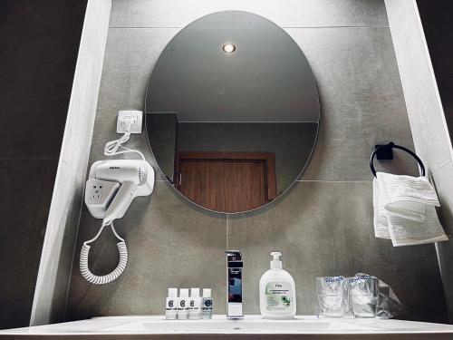 a bathroom with a mirror and a sink at MOZAIK APARTMENTS & SPA - Modern 4-Star Apartments with Exclusive Private SPA WELLNESS in the City Center - SAUNA, JACUZZI, TURKISH BATH - FREE PARKING, Wi-FI - Rooms & Apartments Cuprija in Ćuprija
