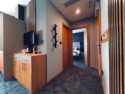 a corridor of a hotel room with a room at MOZAIK APARTMENTS & SPA - Modern 4-Star Apartments with Exclusive Private SPA WELLNESS in the City Center - SAUNA, JACUZZI, TURKISH BATH - FREE PARKING, Wi-FI - Rooms & Apartments Cuprija in Ćuprija