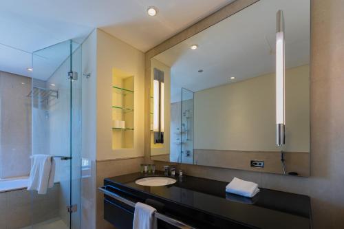 a bathroom with a sink and a mirror at Spacious, Modern Studio in Marina Dubai in Dubai