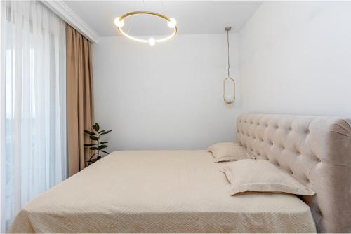 a bed in a bedroom with a large window at ADRIATIC VIEW M in Bar