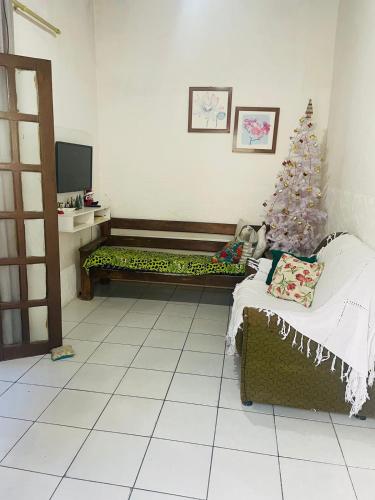 a living room with a christmas tree and a couch at Casa Prox Praia de itapua in Salvador