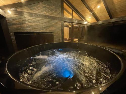 a large tub filled with water in a room at Mountain Residence in Tukhlya