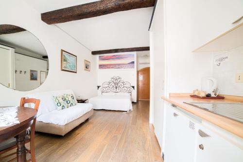 a kitchen and living room with a couch and a table at The Vernazza Main Plaza - Rooms & Suites in Vernazza