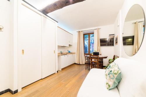 a bedroom with a bed and a kitchen with a table at The Vernazza Main Plaza - Rooms & Suites in Vernazza