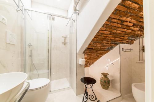 a bathroom with a glass shower and a toilet at The Vernazza Main Plaza - Rooms & Suites in Vernazza
