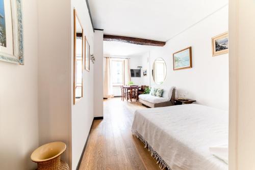 a bedroom with a bed and a living room at The Vernazza Main Plaza - Rooms & Suites in Vernazza