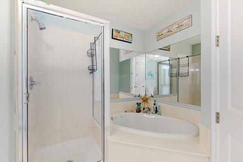 a white bathroom with a shower and a sink at Regency Isle 611 in Orange Beach