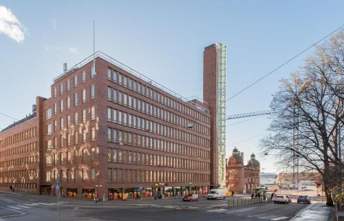 a large brick building on a city street at Modern apartment in a prime location in Helsinki