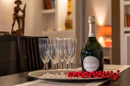 a bottle of wine and two wine glasses on a table at Sant'Ivo Apartments in Rome