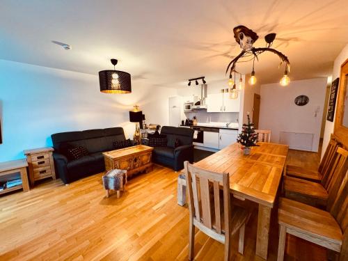 a living room with a table and a couch at PREMIUM SKI IN/OUT - STEINADLER in Obertauern