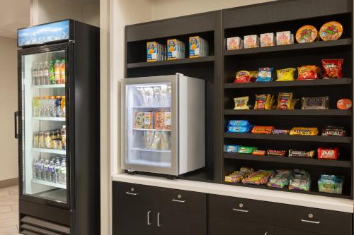 a kitchen with a refrigerator with food in it at La Quinta Inn & Suites by Wyndham Lake George in Lake George