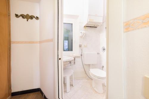 a bathroom with a toilet and a sink at The Vernazza Main Plaza - Rooms & Suites in Vernazza
