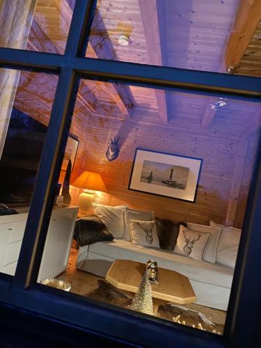 a view of a room with a couch and a table at Ferienhaus Alpenpanorama Chalet in Mollenberg