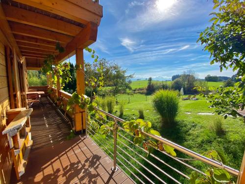 a porch of a house with a view of a field at Ferienhaus Alpenpanorama Chalet in Mollenberg