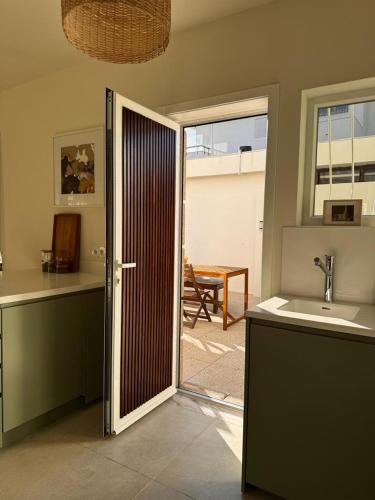 a kitchen with a door leading to a patio at Porto Lidador Boutique Ap with Garden - Alvaro in Porto