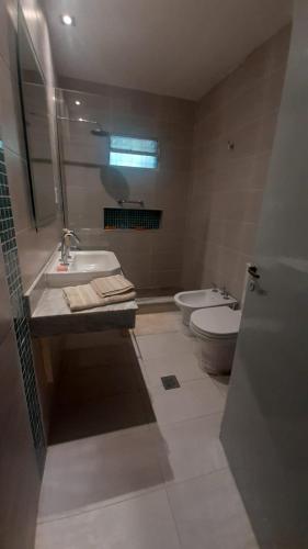 ein Bad mit einem Waschbecken, einem WC und einem Fenster in der Unterkunft La Manquel - Casa y Yungas in Yerba Buena