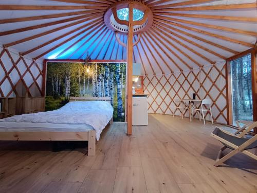 a bedroom with a bed in a yurt at Jurta Na Skraju Lasu 