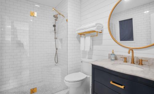 a bathroom with a toilet and a sink and a mirror at 4bd/3ba - Renovated Center Island Home & Garage Apt - Amenity Cards Avail - Pets ok in Fripp Island