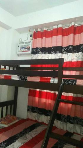 a bunk bed with an american flag on it at 4jMarte Home Stay in Imus