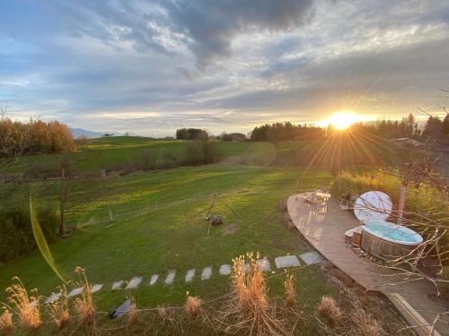 an aerial view of a field with a hot tub at Ferienhaus Alpenpanorama Chalet in Mollenberg