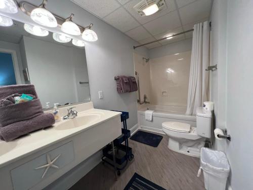 a bathroom with a sink and a toilet and a mirror at 2501 S Ocean Blvd, 1215 - Ocean View Sleeps 8 in Myrtle Beach
