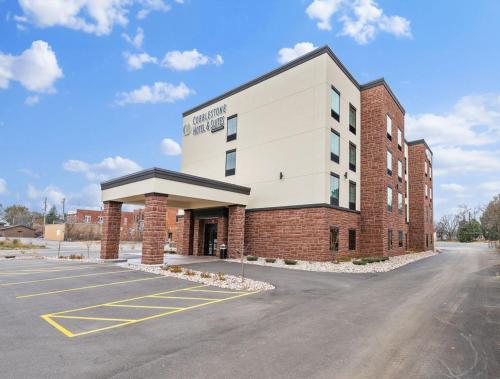 an empty parking lot in front of a building at Cobblestone Hotel & Suites - Mosinee in Mosinee