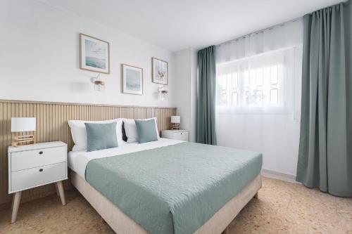 a bedroom with a large bed and a window at Europa Club Apartment, La Cala de Finestrat, Benidorm, Next to the beach, Ground floor, Air Cond in Benidorm