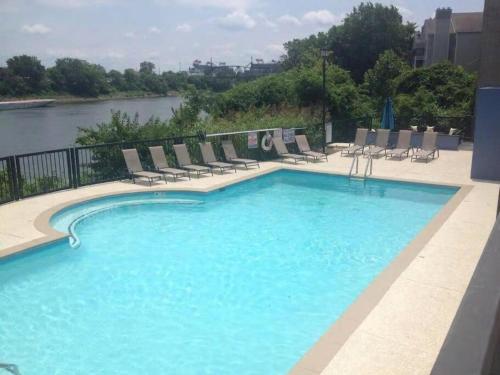 a large swimming pool with chairs and a river at Nashville Downtown Condo -788 in Nashville
